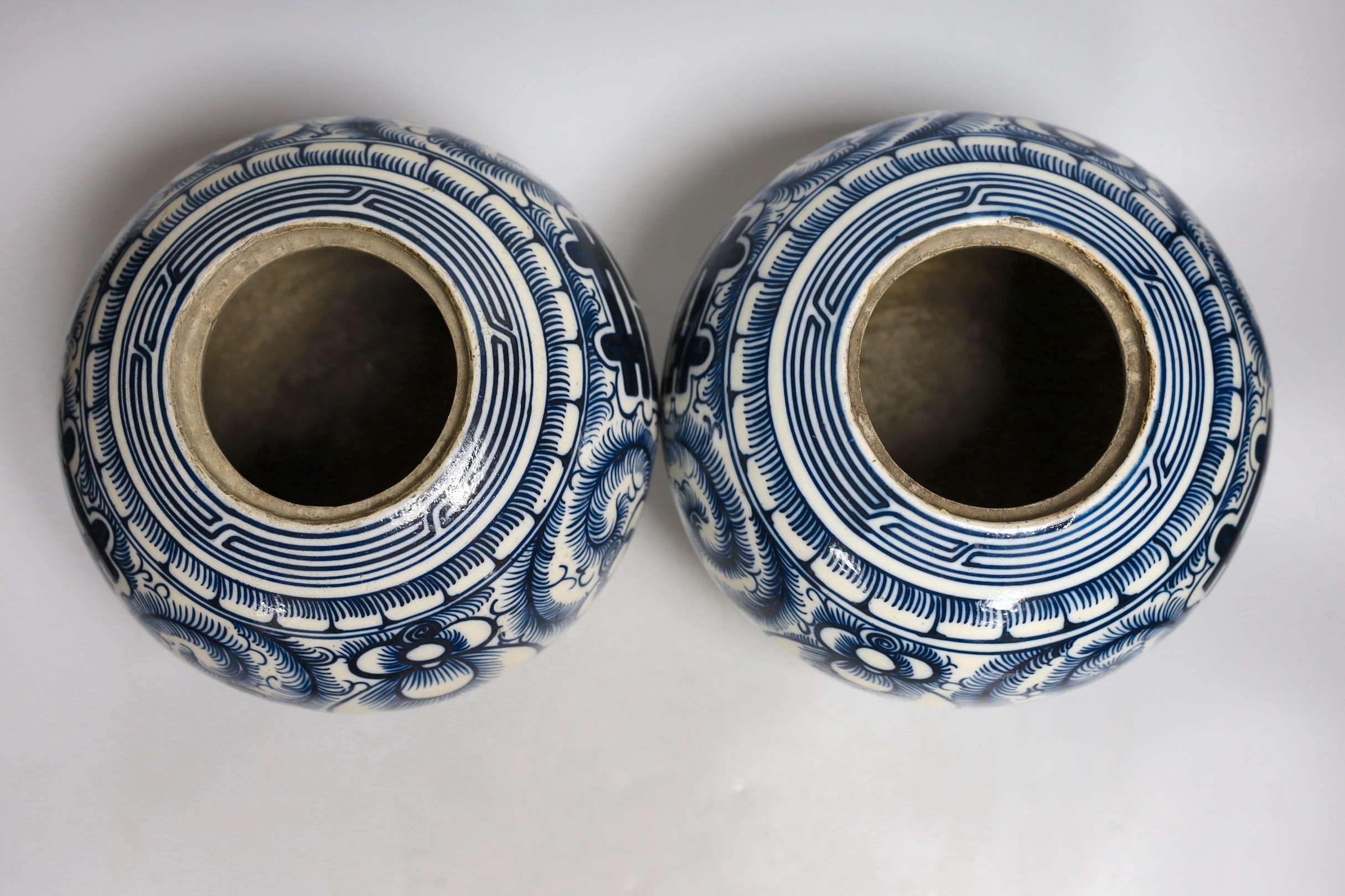 A pair of Chinese blue and white ‘Shuangxi’ jars and cover, 25cms high